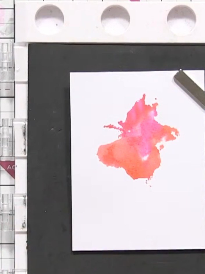 Step 8: Press the stamp down firmly and evenly onto the white card stock with the watercolour background. Ensure good 