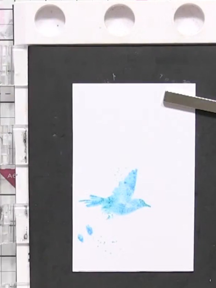 Step 3: Press the wet stamp firmly onto white card stock and hold it in place to allow the blue colours to blend toget