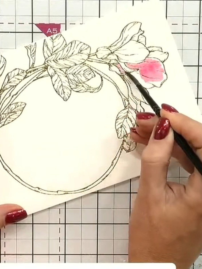 Step 4: Using a paintbrush, apply the pink ink to the flower petals on the hot foiled watercolour card. Allow the colo