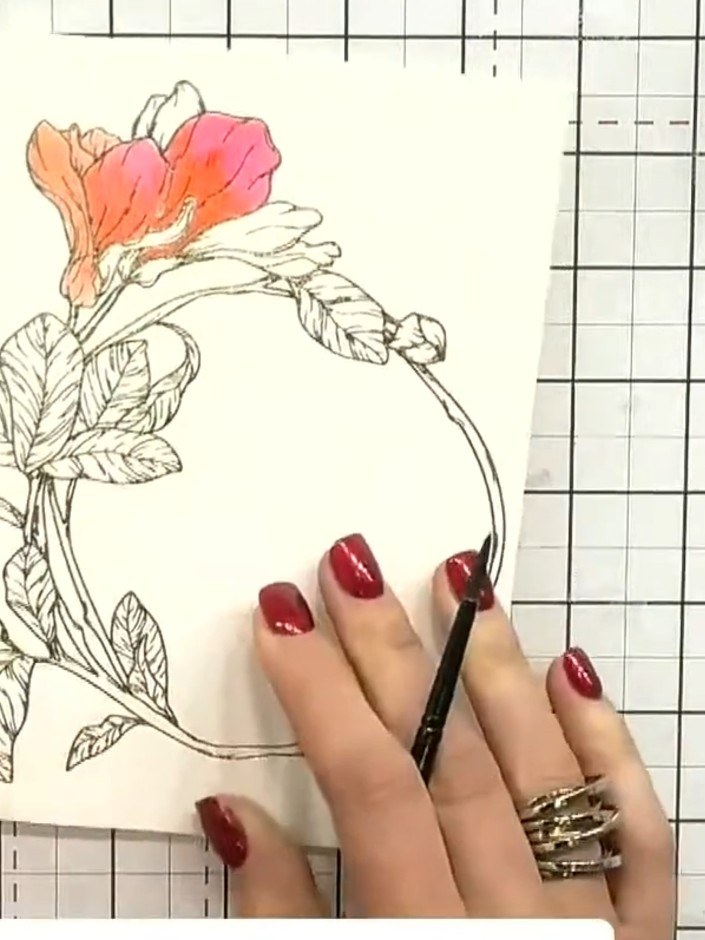 Step 5: Apply orange ink to the areas adjacent to the pink petals, blending the colours where they meet to create a sm