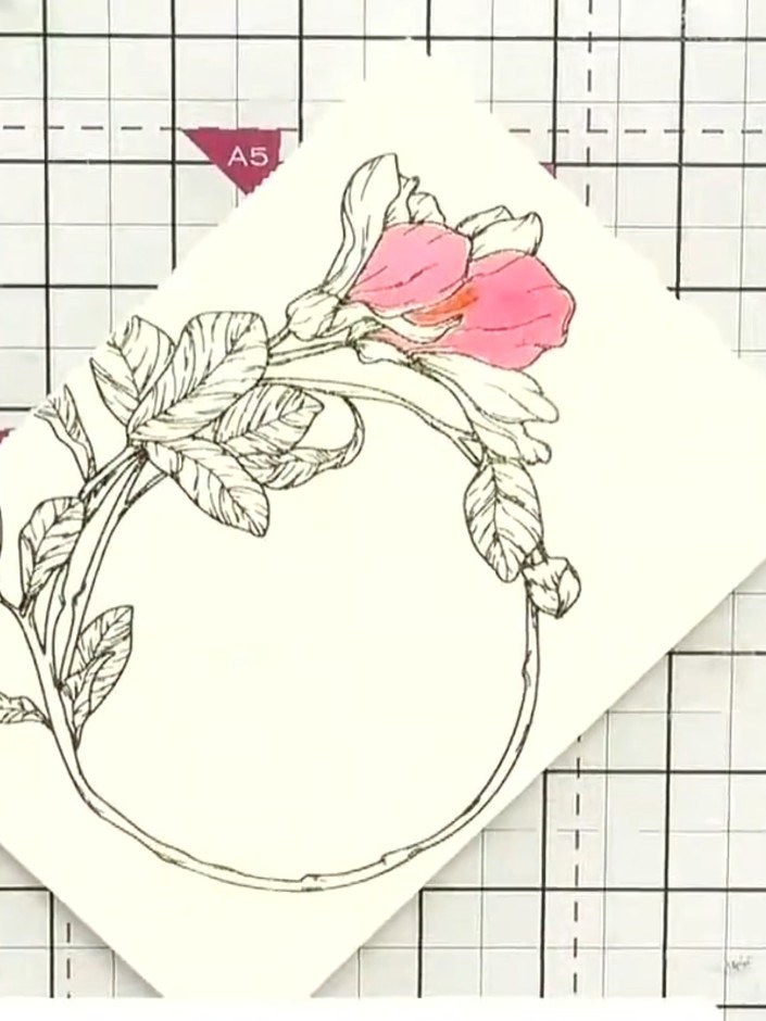 Step 6: Using green ink, paint the leaves and stems of the floral design. Add depth and dimension by layering the colo