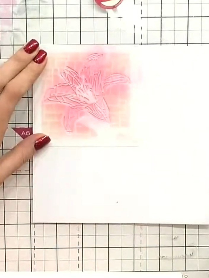 Step 10: Use a blending brush to add pink ink around the embossed lily design, creating a soft halo effect. Build up th