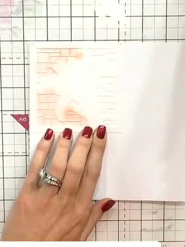 Step 5: Position stencil number two over the design, aligning it carefully with the previous layer. Hold the card stea