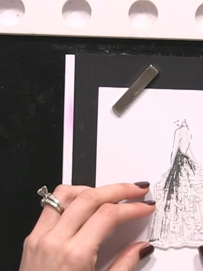 Step 3: Apply teal and purple ink pads to the dress area of the stamped lady using a sponging or blending technique. B