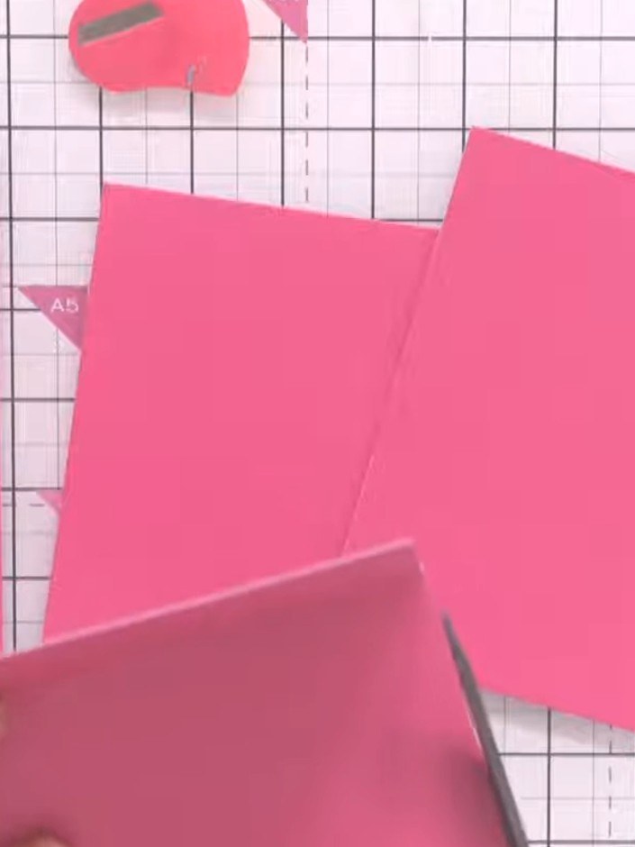 Step 1: Using a guillotine or craft knife, cut your pink A5 card blanks into different sizes to create variety in your
