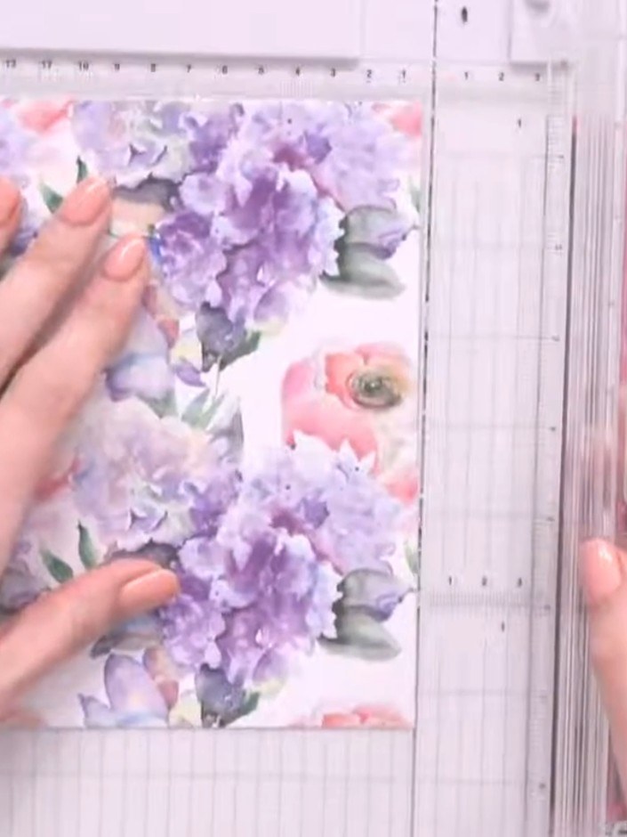 Step 1: Select a patterned paper featuring purple hydrangeas and pink flowers. Place it on your scoring board and use 