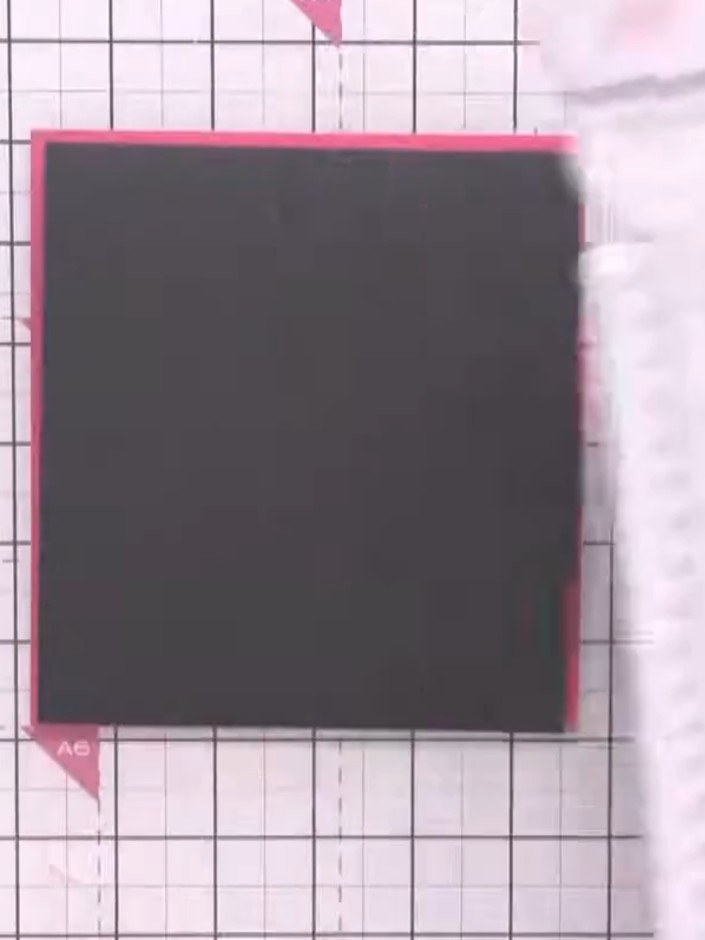 Step 6: Glue the black connector strip down the centre of the card, positioning it between the two floral panels to cr