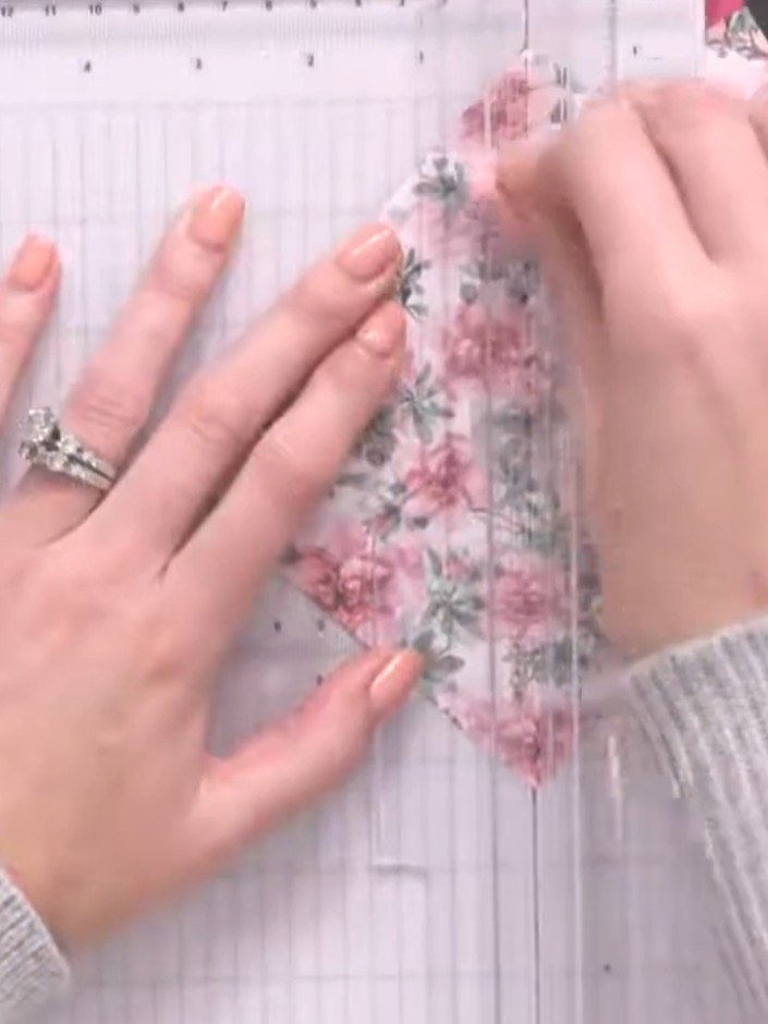 Step 7: Position the second floral patterned paper piece on the right side of the white dotted panel and smooth it dow
