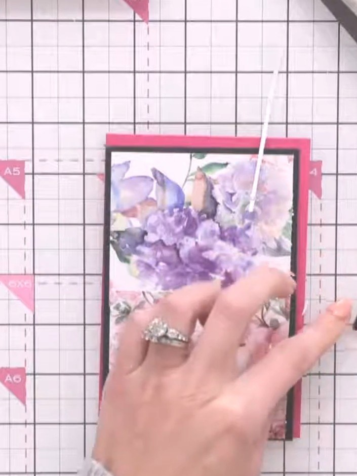 Step 4: Apply adhesive to the back of your first floral paper panel. Position and adhere it to the pink card base, ali