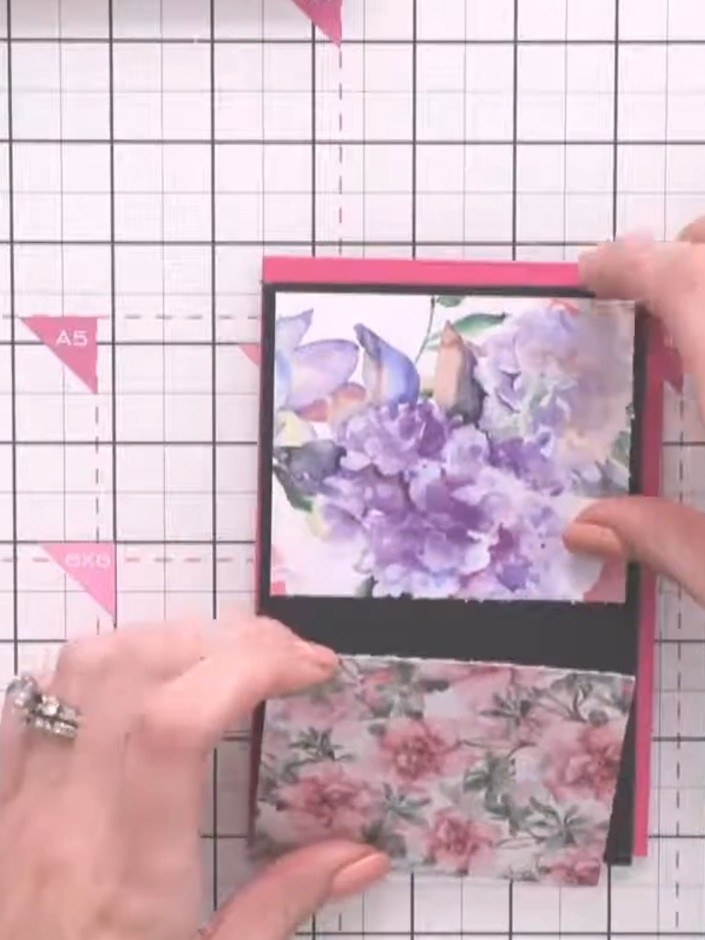 Step 5: Glue the black connector strip horizontally across the centre of the card base, bridging the two floral panels