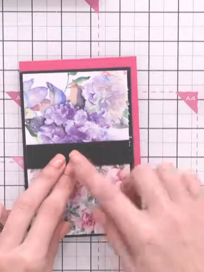 Step 6: Attach your second floral paper panel below the black connector strip on the pink card base, aligning it caref