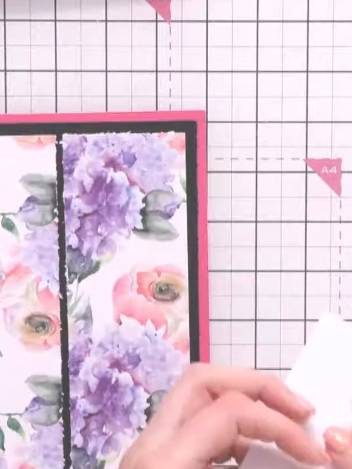 Step 1: Select a floral patterned paper featuring purple and pink flowers. Adhere it to your pink card base, creating 