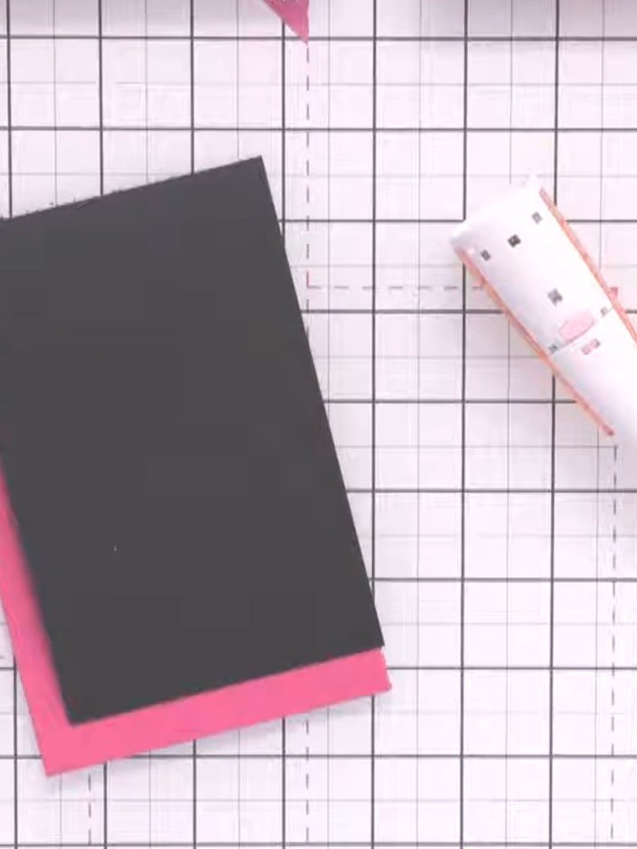 Step 1: Cut a card base from black cardstock and layer it onto a pink card base. Using a ruler and pencil, lightly mar