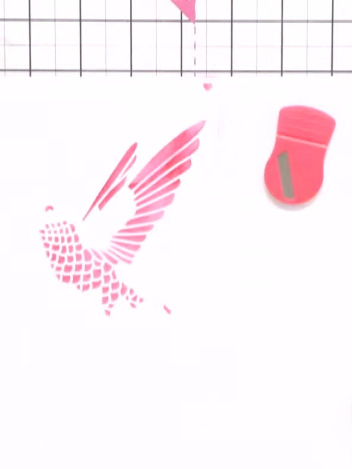 Step 4: Using the edge of your paper as a guide, apply the darker pink or magenta ink through stencil three with a ble