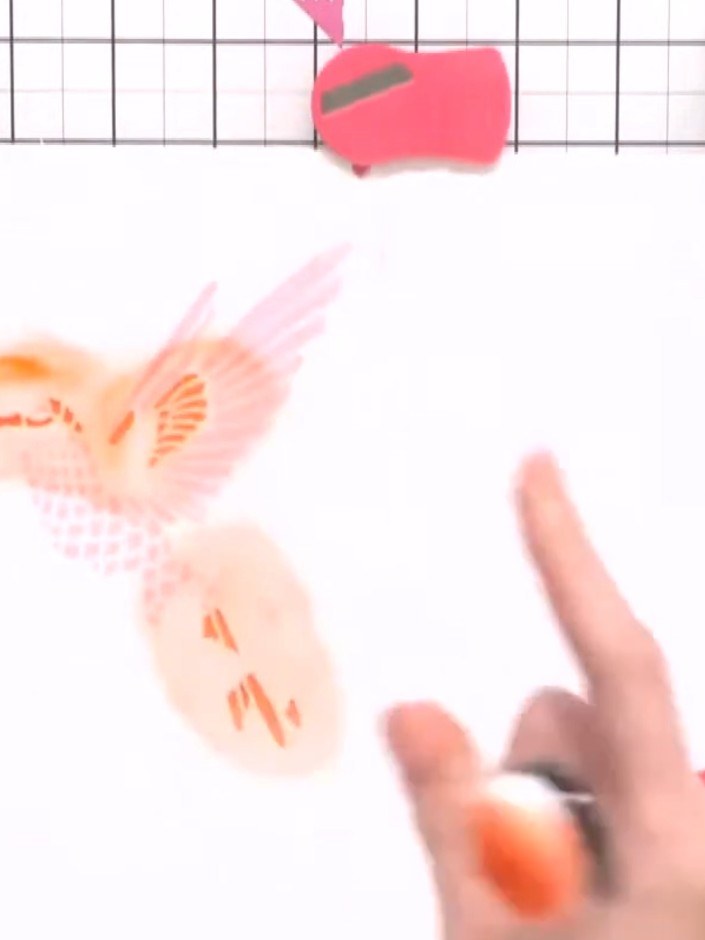 Step 5: Apply the fourth stencil using a darker shade of ink with your blending tool, pressing firmly to create depth 