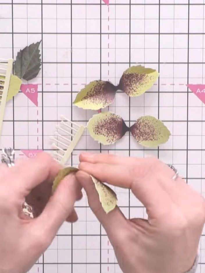Step 5: Curl the yellow and brown flower petals inward using your fingers to create dimension and shape for the helleb