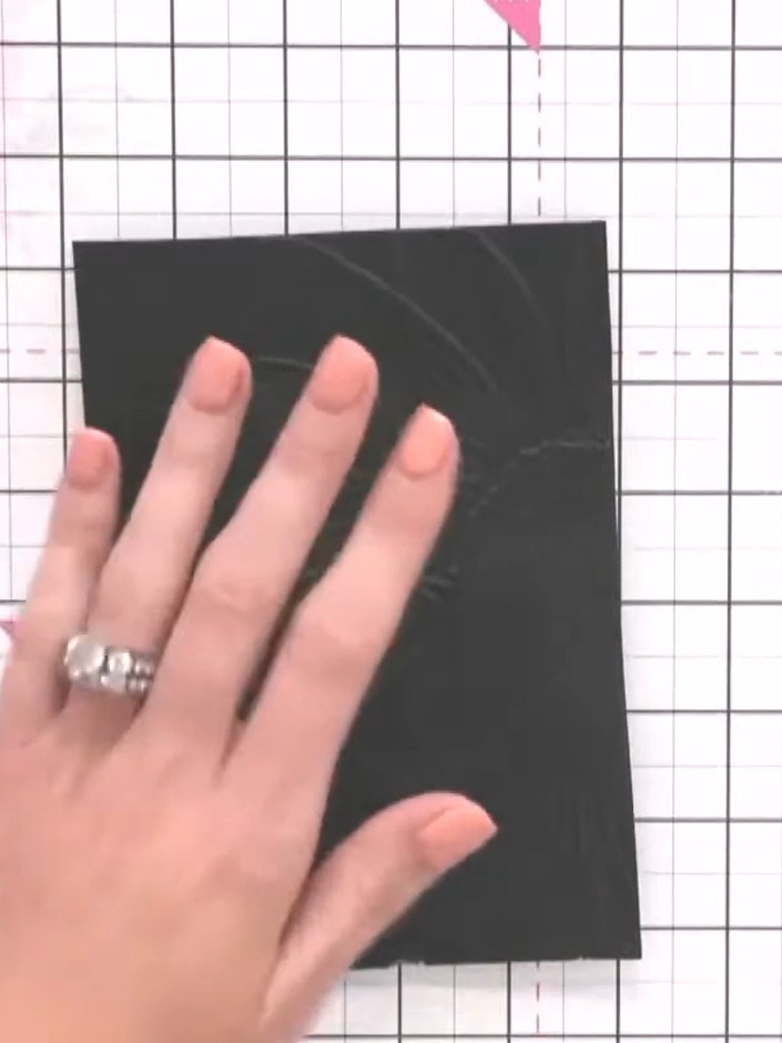Step 2: Examine the embossed detail on the black card, noting the dimension and texture created by the embossing folde