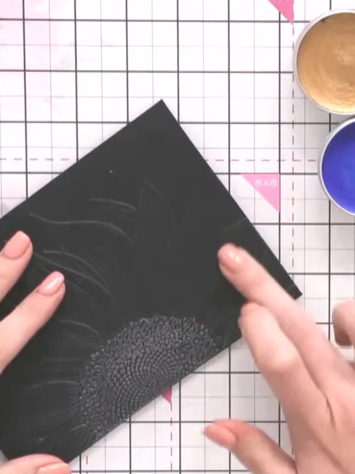 Step 4: Apply gilding wax to the embossed sunflower petals using your finger or a brush. Work the wax into the raised 
