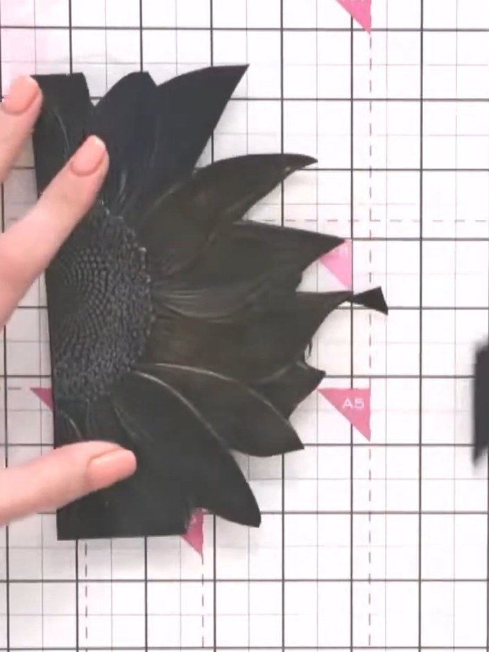 Step 8: Adhere the black embossed flower panel to the front of your card base. Position it centrally to create a strik