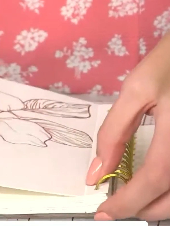 Step 1: Tear out a page from the hot foiled colouring book along the perforation line by holding the book steady and g