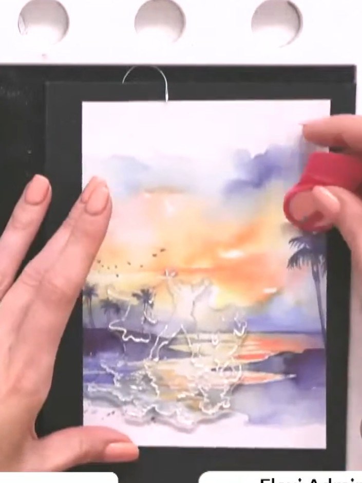 Step 3: Stamp the family silhouette image in black ink onto the sunset background paper. Position the stamp towards th