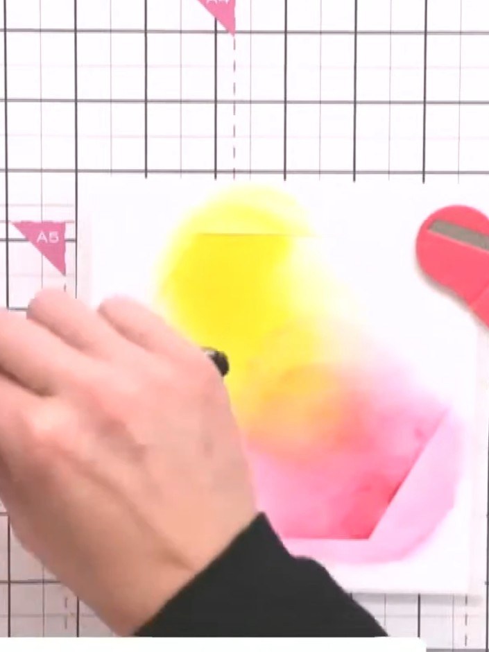 Step 3: Apply yellow ink through the stencil using a blending brush. Blend the ink across the area, working it into th