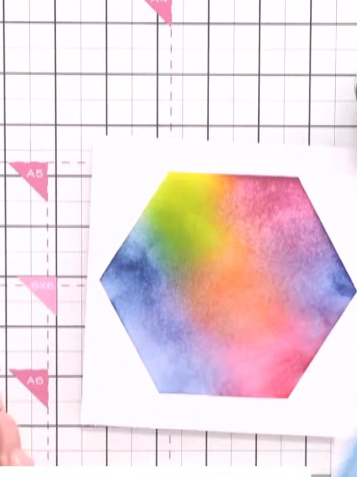 Step 6: Apply teal ink through the hexagon stencil using a blending brush to complete the multicolour background blend