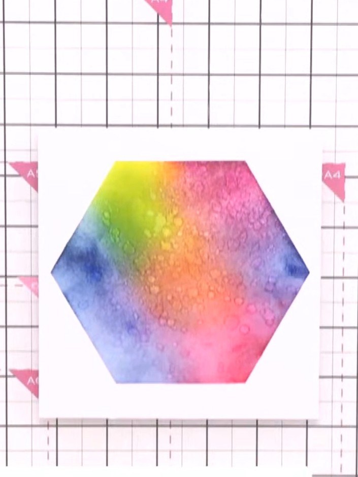 Step 7: Carefully lift and remove the honeycomb stencil to reveal the rainbow gradient hexagon aperture with glitter t
