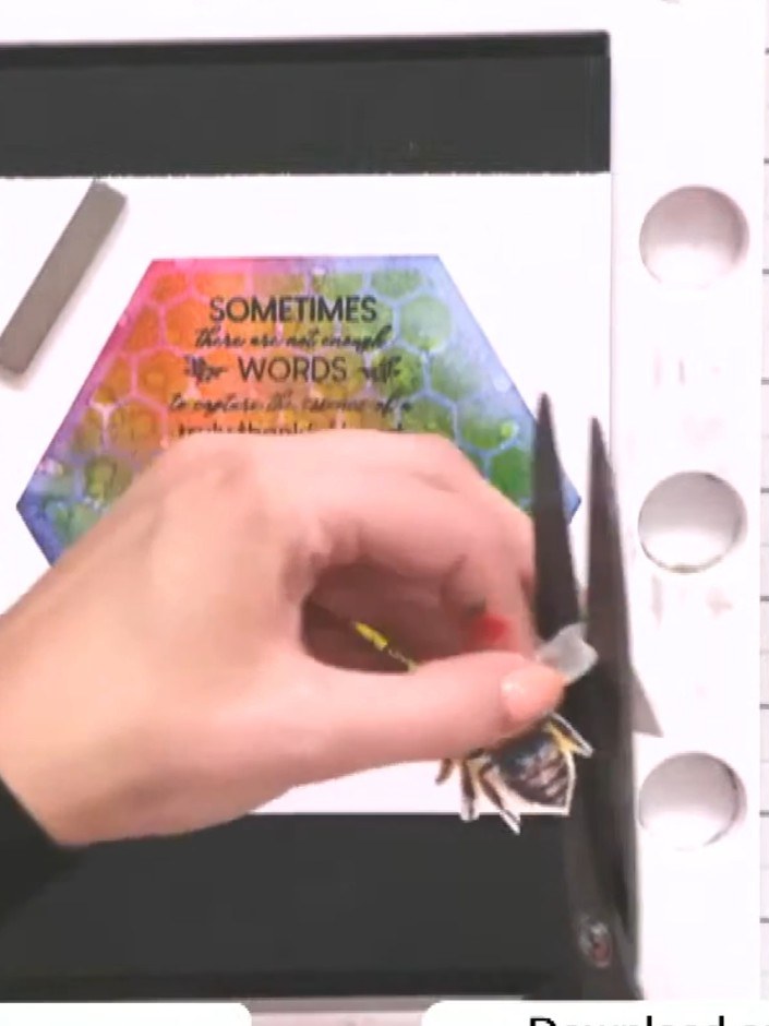 Step 3: Apply glue to the back of the fussy-cut bee using a glue pen or adhesive. Ensure the entire back surface is co