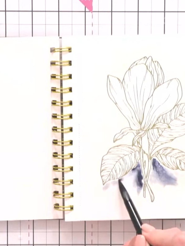 Step 5: Use a wet brush to drag and blend the purple colour outwards from the magnolia petals, creating a soft halo ef