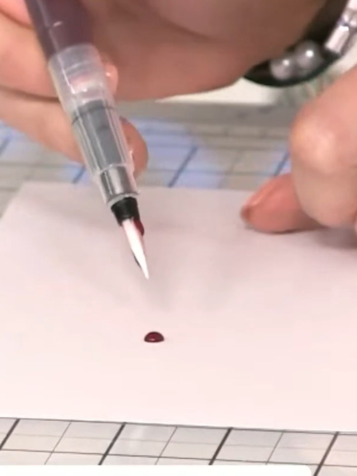 Step 4: Squeeze the barrel of the water brush pen until the colour comes through to the brush tip. Test on scrap paper
