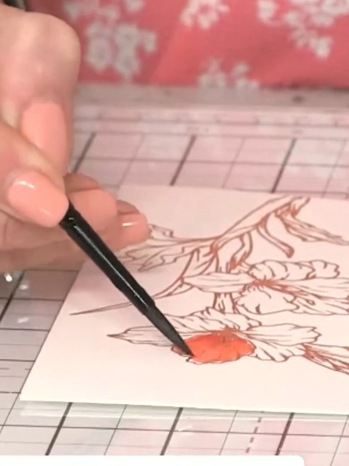 Step 5: Using the brush tip of your watercolour marker, apply a small amount of orange pigment to one of the flower pe