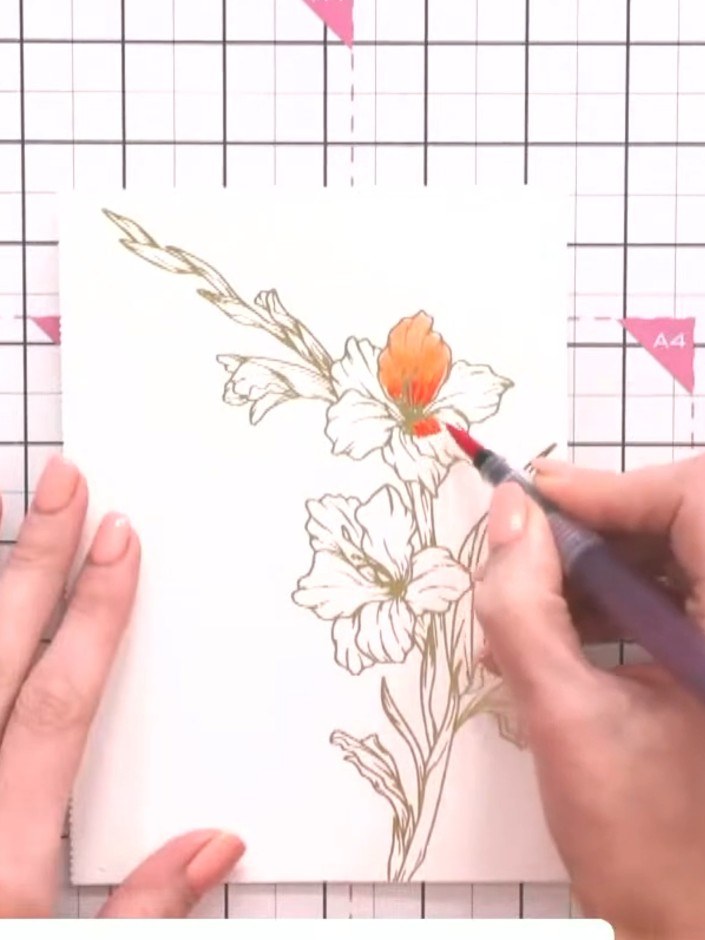 Step 6: Dampen a clean brush with water and drag the orange colour outward from the centre to blend and dilute it acro
