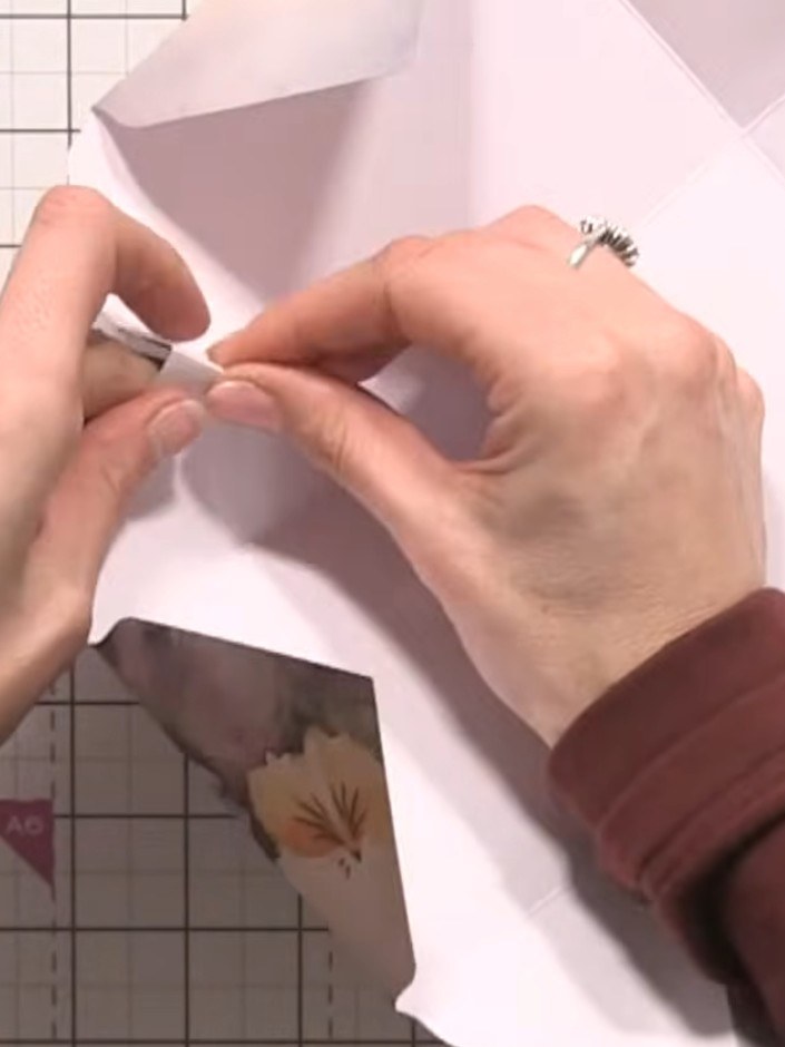 Step 8: Take your pre-cut floral die-cuts in various colours and fold some of them in half to create dimension for you