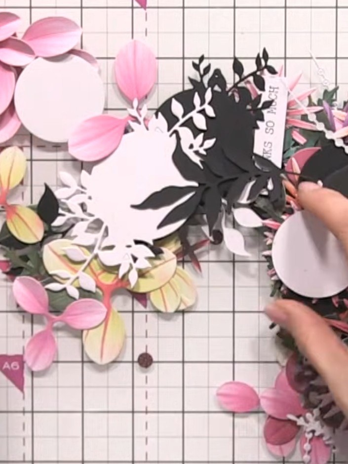 Step 9: Begin layering the paper flowers onto the box lid. Tuck the flowers in amongst each other to create a full, di