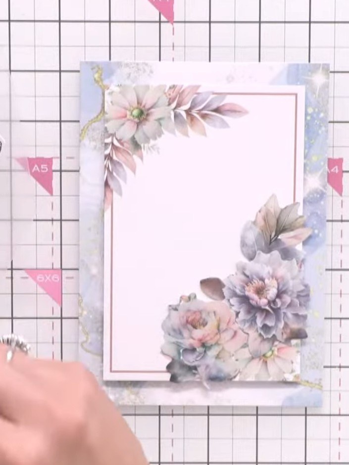 Step 5: Arrange embellishments around your main topper, using black and white swirl die-cuts to break up the floral de