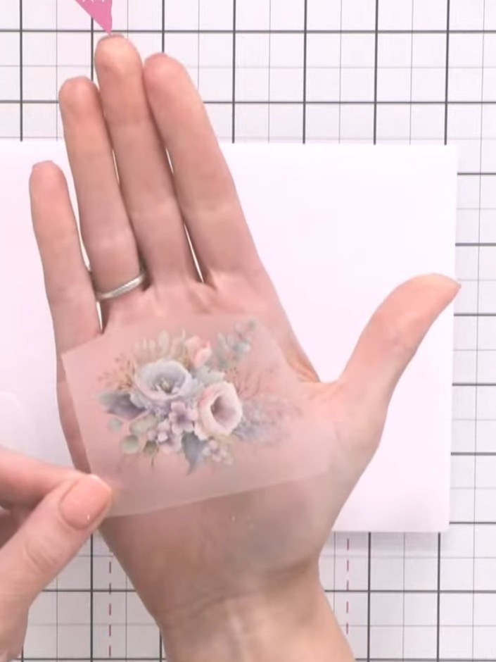Step 1: Select your chosen floral rub-on design from the sheet. Position the design on the corner of your envelope and