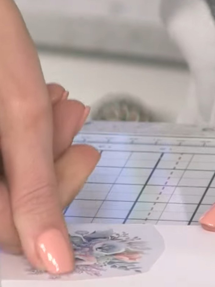 Step 4: Use your fingernail, a ruler edge, or a flat tool to burnish the floral rub-on transfer design firmly onto the