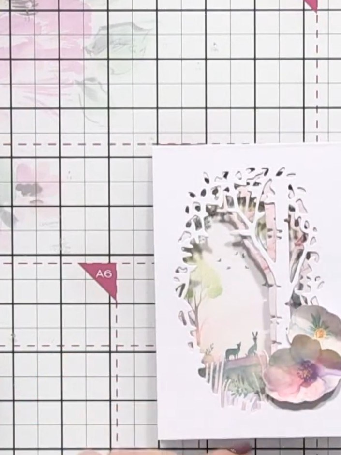 Step 10: Layer the paper flowers using foam pads to create dimension. Tuck the leaves and flowers into the aperture win