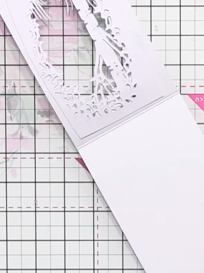Step 8: Position the layered aperture frame onto your white card blank. Adhere it in place using adhesive to complete 