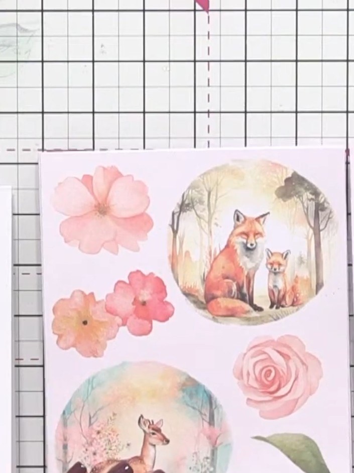 Step 9: Fussy cut flowers, greenery, and animal motifs from the embellishment pack. Select elements such as birds, flo