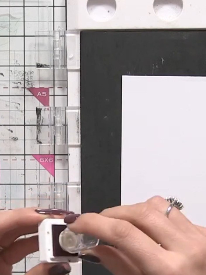 Step 3: Add purple ink down one side of the stamp using the sponge applicator. Apply the ink directly to the raised su