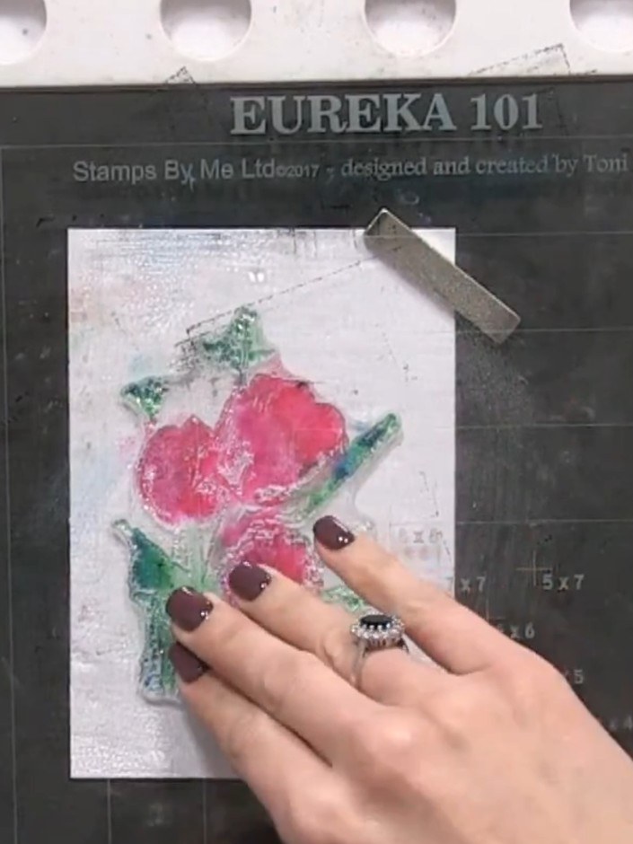 Step 6: Press the stamped image firmly onto your white card blank to transfer the watercolour effect. Ensure even pres