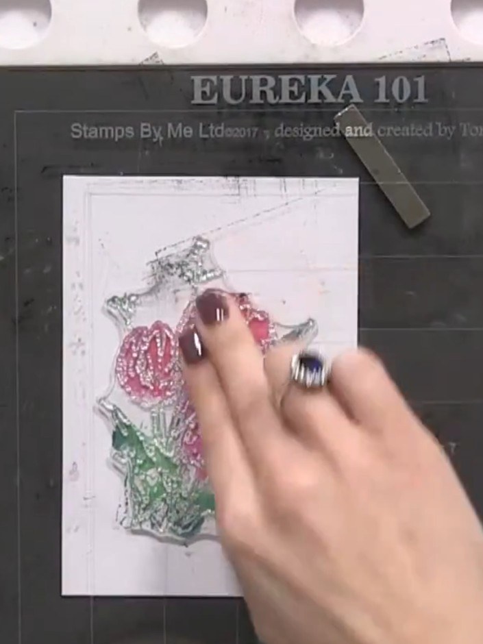 Step 9: Line up the outline stamp over the dried watercolour image, using the registration marks on your stamping plat