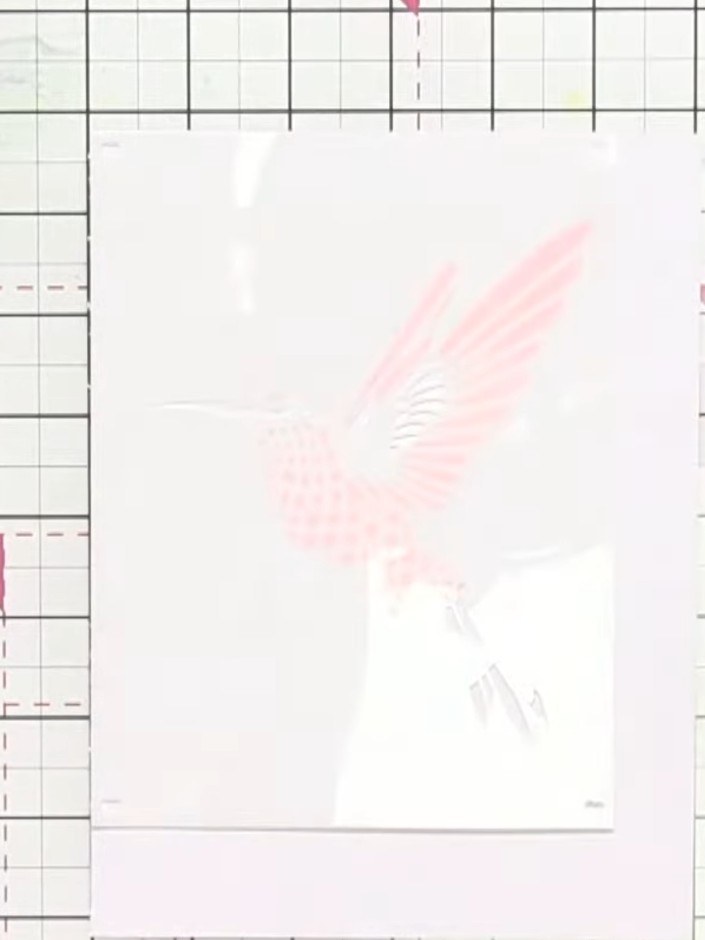 Step 4: Remove stencil one and position stencil two in the same corner. Apply pink ink through the stencil using a ble