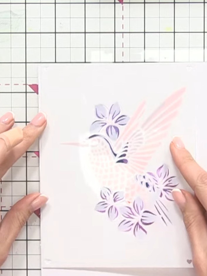 Step 7: Apply sparkle paste through stencil four over the purple flower and leaf areas to add dimension and shine. All