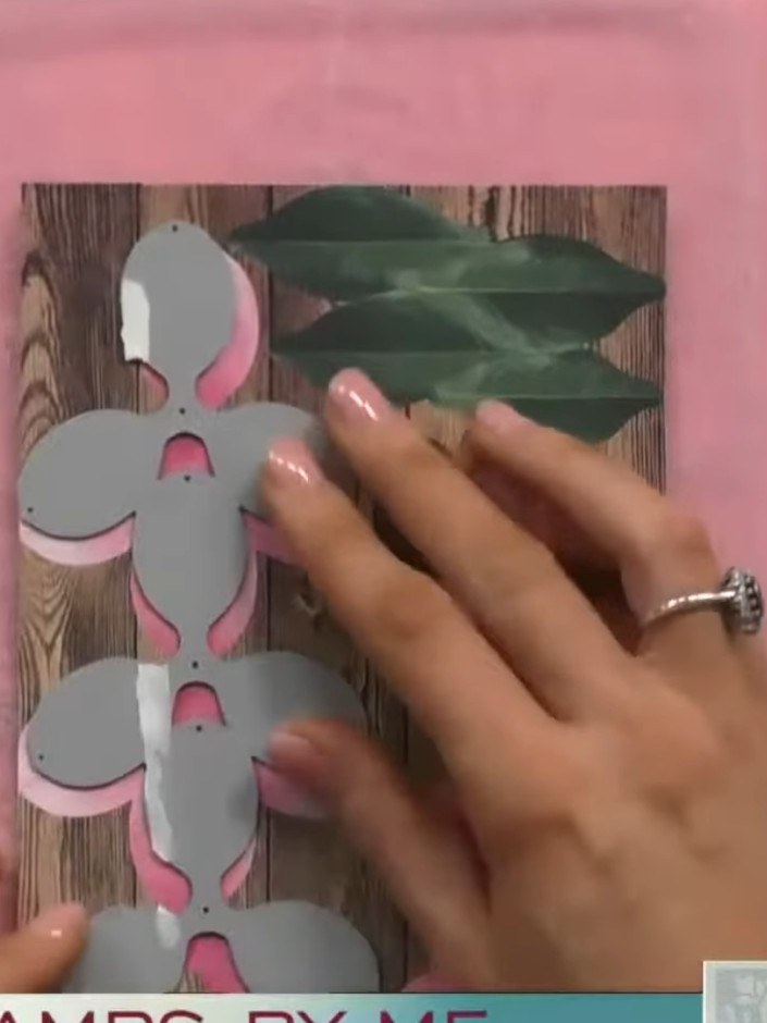 Step 3: Place the die-cut flower pieces onto your card stock on the pink cutting mat. Run the die and card stock throu