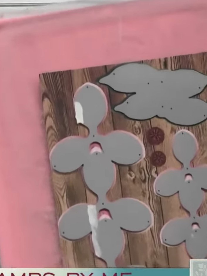 Step 6: Layer the three grey die-cut petals together on the wood-effect background panel. You can choose to display ei