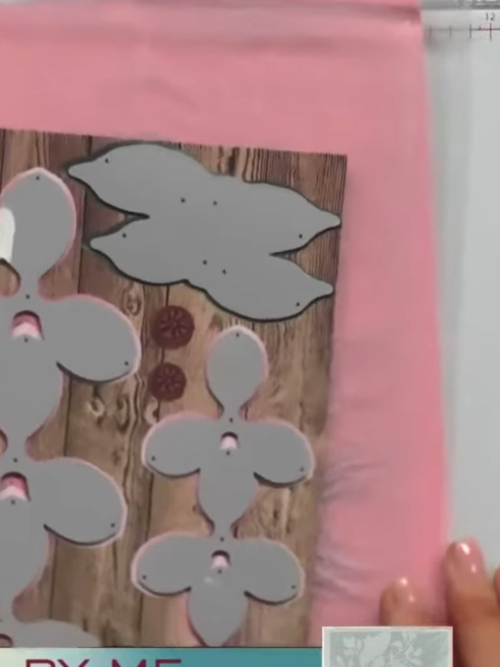Step 8: Add the small circle centre pieces to the grey flower shapes in a contrasting pink colour to create a plaque e