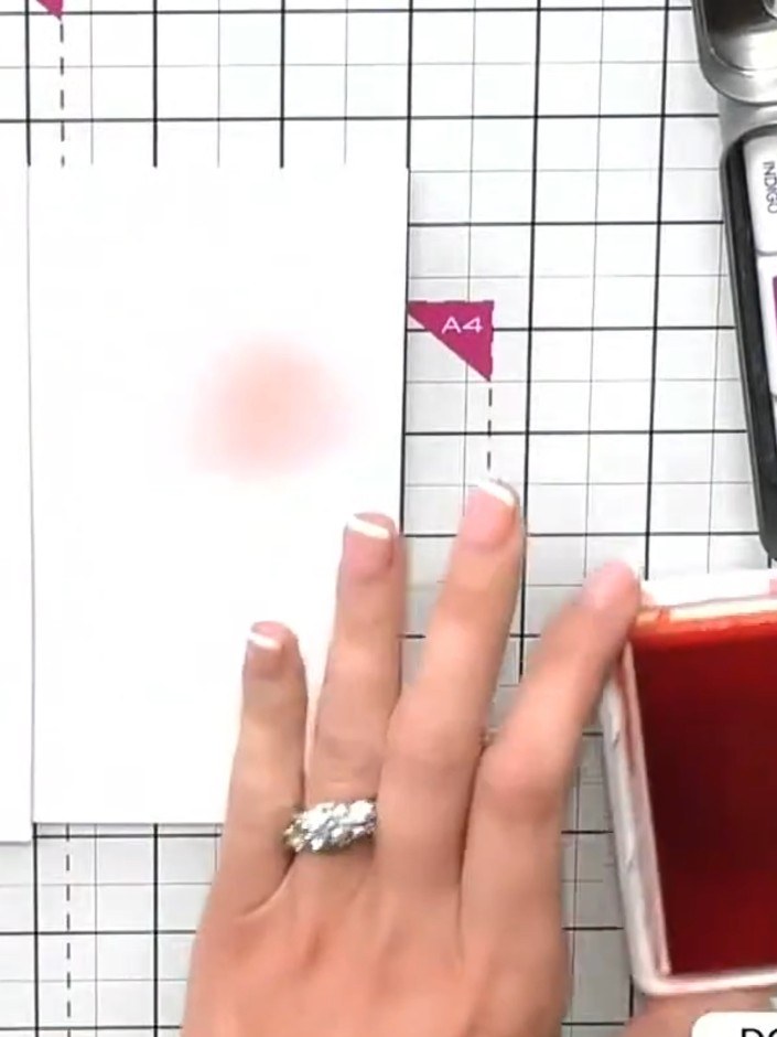 Step 3: Using a blending brush, pick up orange ink from the ink pad. Tap the brush on your craft mat to remove excess 